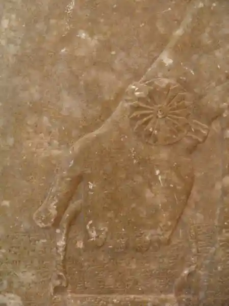 Genie in front of a tree of life, solar disc on the wrist